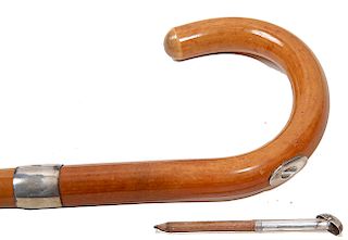 92. Touter’s Cane- Ca. 1900- A Swain and Brigg system cane which has a 3 ½” removable pencil, large British hallmarked silver collar, thick malacca sh