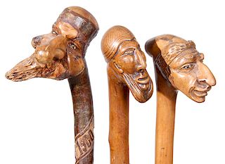 119. Three Folk Art Portrait Canes- Ca. 1900-  A group of three fine carvings with nice original finish and all three have ferrules, one has a pair of