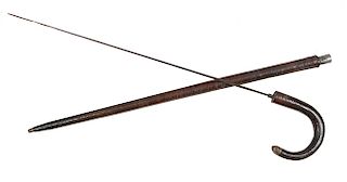 196. Sword Cane- Ca. 1880- An unusual stacked leather sword cane with a brass endplate, 28” forged blade with a push and pull mechanism, shaft is 1 ½”