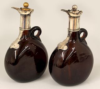PAIR OF AMBER GLASS AND SILVERED LIQUOR BOTTLES