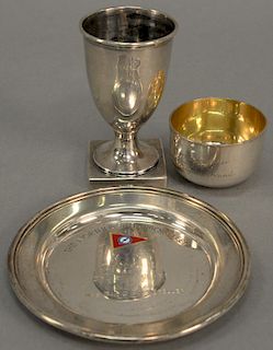 Three silver pieces to include a small hand hammered cup with gold wash interior marked: "Peggy Rockefeller The Gift of Two English ...