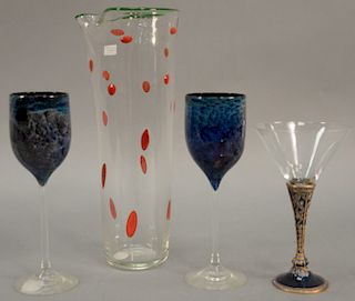 Four piece art glass group to include Berebi enameled stemmed martini glass, two art glass wine stems, and an art glass pitcher sign...