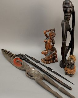Six carved pieces to include Rosewood carved figure of a topless woman, a carved spear, a small figure with shell eyes, two African...