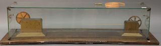Foote Pierson, Ticker tape, bronze double reel, on rectangle base under glass case, marked: single circuit punch Type C, serial numb...