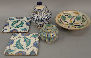 Five piece lot to include two Persian style tiles (each with crack), two covered jars, and one bowl. tiles: 9 1/2" x 9 1/2" 

Proven...