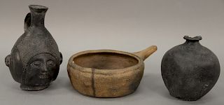 Three piece group to include South American clay face jug, small black painted clay vase, and a carved stone cooking vessel. jug: he...