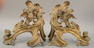 Pair of Louis XV style chenets, each mounted with winged dragon. height 15 inches, width 15 inches.   Provenance: Estate of Pegg...