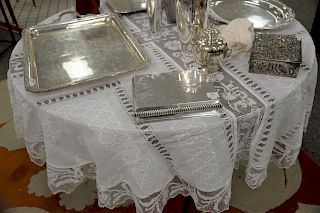 Thirteen piece lot to include four tablecloths, three round and one rectangle, and nine napkins.
