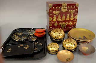 Two tray lots of lacquered items to include set of four painted plates, two Japanese stem cups painted with figures, three gold and...