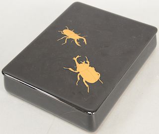 Japanese black lacquered beetle box having two gilt beetles on the cover in original box.  height 2 1/2 inches, top: 8 1/2" x 11"...