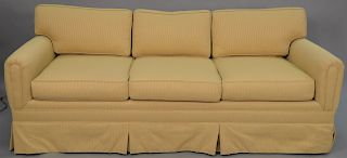 Custom upholstered three cushion sofa with tan upholstery. length 85 inches.   Provenance: Estate of Peggy & David Rockefeller h...