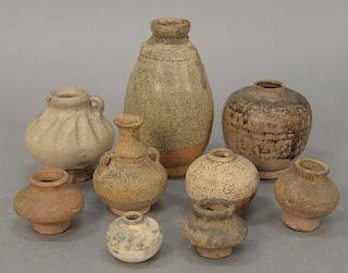 Group of nine ancient archaic clay and ceramic vases and urns to include six miniature vases and three glazed small vases; Roman, Eg...