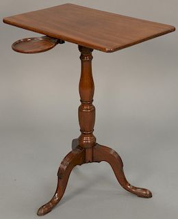 George III mahogany candle stand having swing out candle holder under top. height 27 inches, 13 1/2" x 22" 

Provenance: Estate of P...