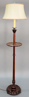Mahogany floor lamp with small round shelf. total height 56 inches   Provenance: Estate of Peggy & David Rockefeller having stam...