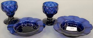 Pair of cobalt blue quilted hand blown stem glasses (possibly sandwich glass), and a pair of cobalt blue flower form saucers with sc...
