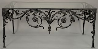 Iron glass top table with scroll work decoration on three sides (small chip in corner). height 32 inches, top: 33" x 70" 

Provenanc...