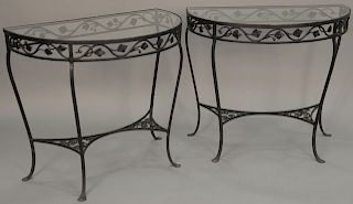 Pair of iron and glass top demilune tables. height 29 inches, top: 32 1/2" x 19 1/2" 

Provenance: Estate of Peggy & David Rockefell...