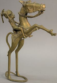 African brass horse and rider sculpture. height 12 inches, length 12 1/2 inches   Provenance: Estate of Peggy & David Rockefelle...