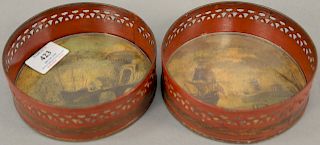 Pair of red and gilt tole bottle coasters having painted seascape with ship in harbor scene on interior of coaster, covered with gla...