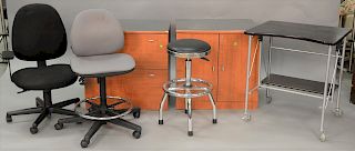 Six piece office furniture lot to include two file cabinets, two office chairs, a chrome stool, and a two tier contemporary desk on...