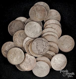 Thirty-two Peace silver dollars.