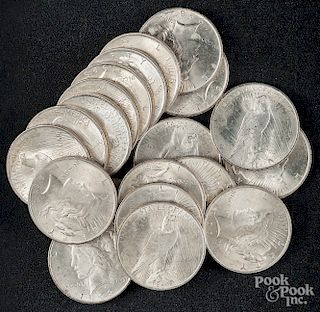 Twenty Peace silver dollars.