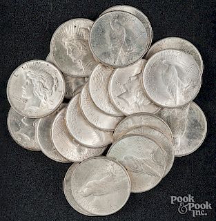 Twenty Peace silver dollars.