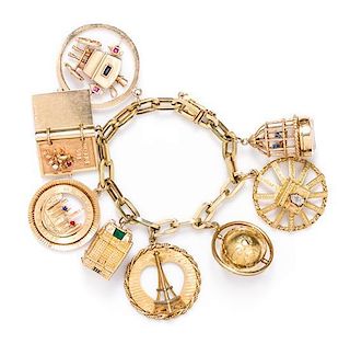 A Yellow Gold Multi Gem Charm Bracelet with Eight Attached Charms, 66.00 dwts.
