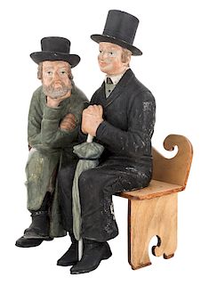 A BISQUE FIGURINE OF A JEW AND GENTILE SITTING ON A BENCH, PROBABLY AUSTRO-HUNGARIAN, CA 1900