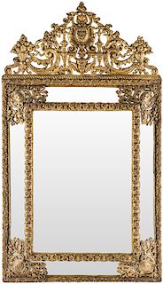 AN ANTIQUE FRENCH GILT METAL REPOUSSE WALL MIRROR