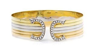 An 18 Karat Tricolor Gold and Diamond Bangle Bracelet, 16.50 dwts.