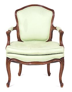 A Louis XV Style Carved Walnut Fauteuil Height 30 1/2 inches.