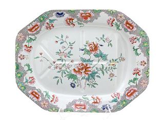 An English Polychromed Decorated Stoneware Well-and-Tree Platter Length 20 inches.