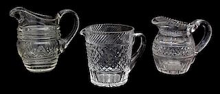 A Group of Three Cut Glass Pitchers Height of tallest 7 1/2 inches.