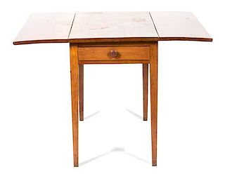 A Walnut Drop Leaf Table Height 28 1/2 x width with leaves up 40 x depth 35 inches.