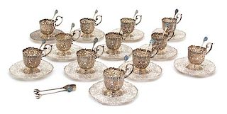 A Set of Twelve Continental .800 Silver Demitasse Cup Holders with Undertrays, , having pierced floral and bird decorated border