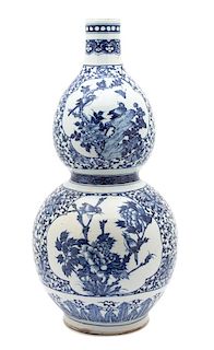 A Chinese Export Blue and White Porcelain Gourd Vase Height 22 1/2 inches.
