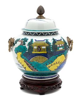 An Asian Polychromed Porcelain Covered Jar Height 14 x diameter 10 inches.