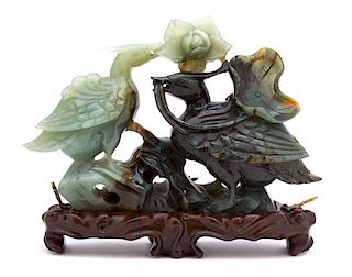 A Chinese Carved Jadeite Model of Two Birds with Lotus Blossom Height 6 1/2 x width 9 1/2 inches.