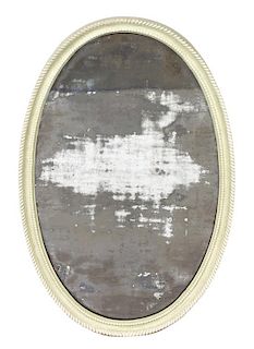 A Carved and Green Painted Oval Mirror Height 39 1/2 x width 24 inches.