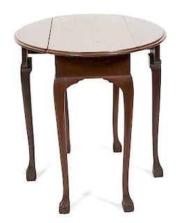 A Chippendale Style Mahogany Oval Drop Leaf Table Height 27 1/2 x width 35 1/4 x depth 26 1/2 inches.