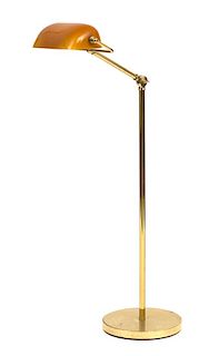 An Adjustable Brass Floor Lamp with Amber Glass Shade Height 46 inches.