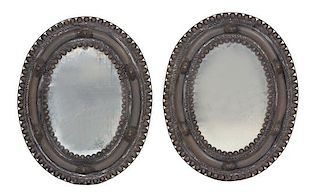 A Pair of Stamped Metal Oval Mirrors 30 1/2 x 24 inches.