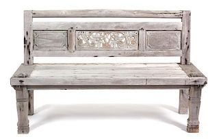A South East Asian Carved Weathered Teak Bench Height 36 x width 59 1/4 x depth 26 1/4 inches.