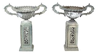 A Pair of Patinated Metal Garden Urns on Pierced Bases Height 33 inches.