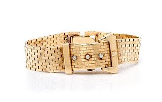 A 14 Karat Yellow Gold and Diamond Belt Motif Surprise Wristwatch, 34.66 dwts.