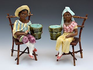 Pair of seated West Indies figures on chairs