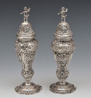 Pair of cast German 800 silver repousse salt & peppers with putti