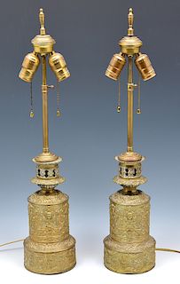 Pair of floral repousse and figural brass lamps