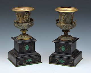 Pair of continental patinated bronze inlaid urns on stand